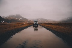 Jeep driving on a muddy road through the mountains