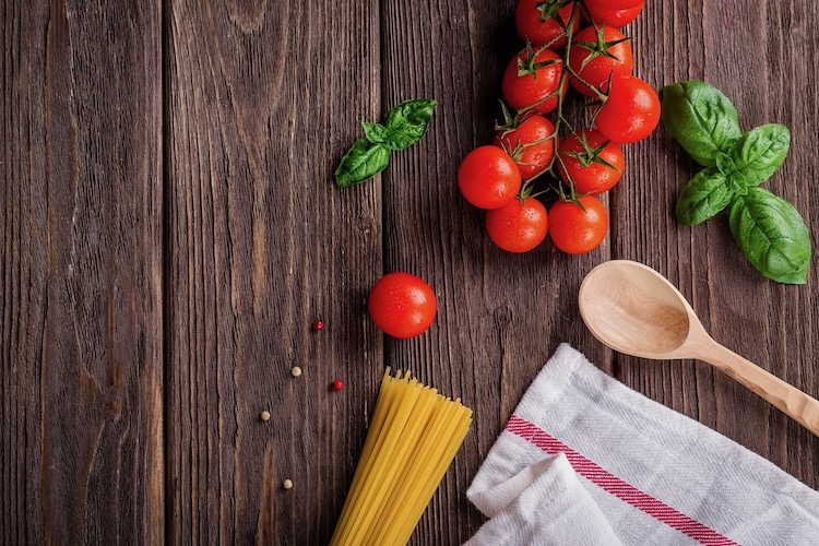 Vegetables and pasta on a wooden table. 