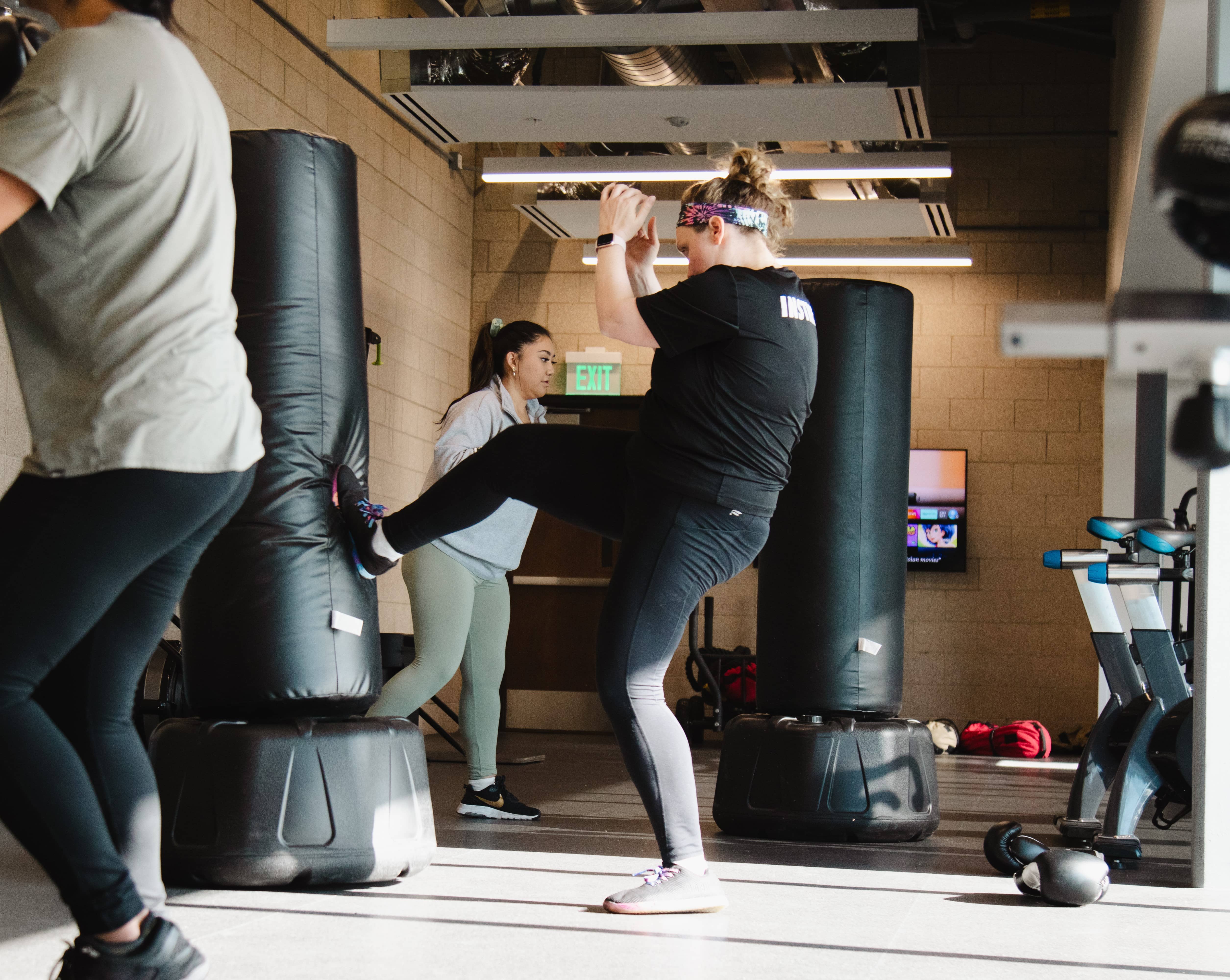 Woman kicking a kick boxing bag