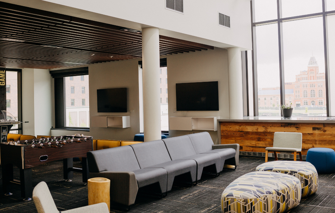 Photo of the Den Game Lounge on the second floor of the wellness center, with view of the Tivoli, Games, Relaxation, and More