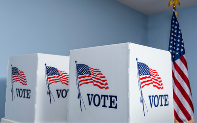 voting booths and American flag