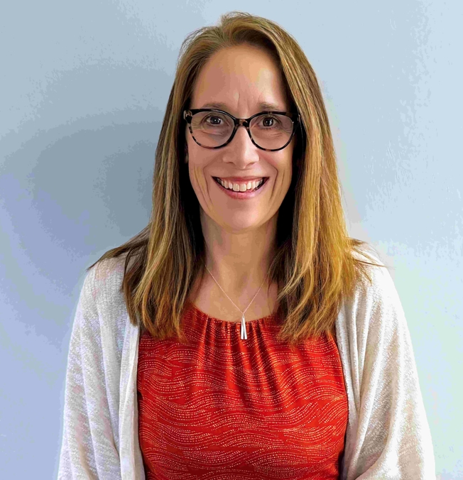 Image of Jenn Leiferman in red shirt with white jacket