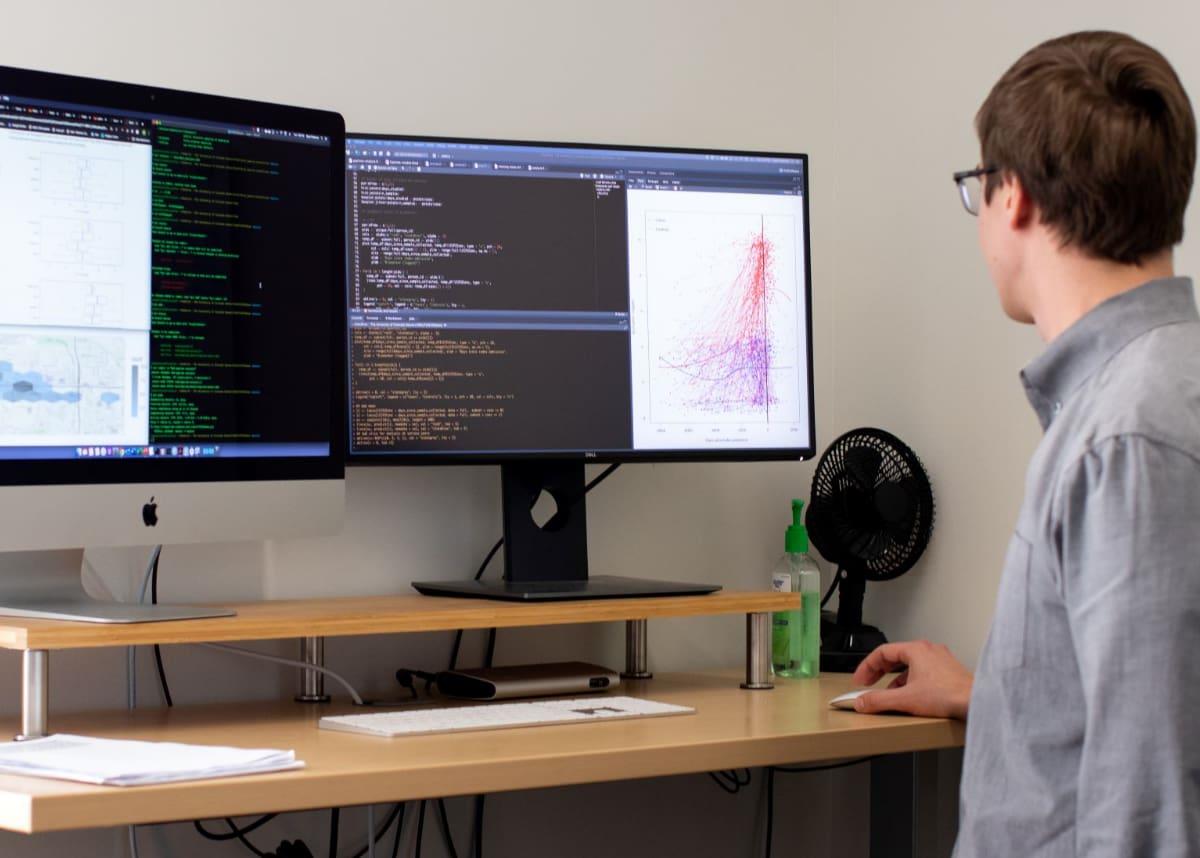 Statistician looking at data and graphs on computers