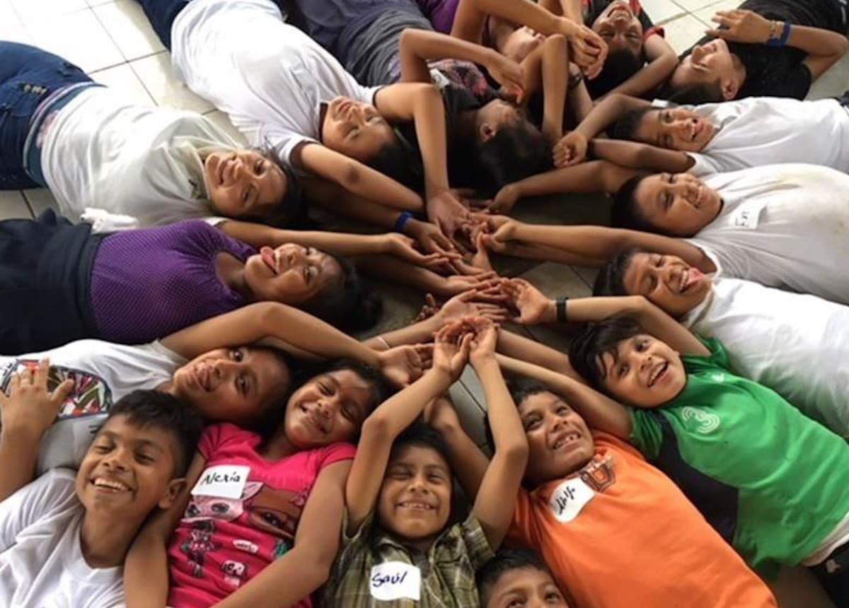 kids laying in a circle smiling