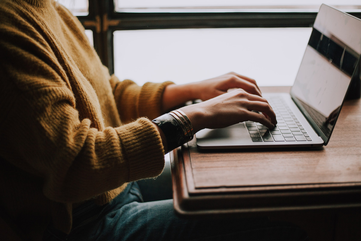 person typing on their computer