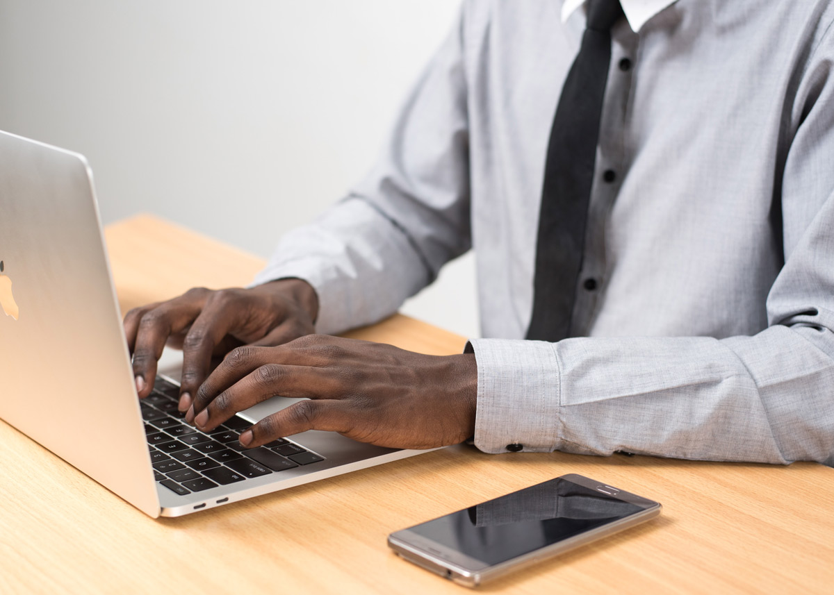 hands typing on a laptop