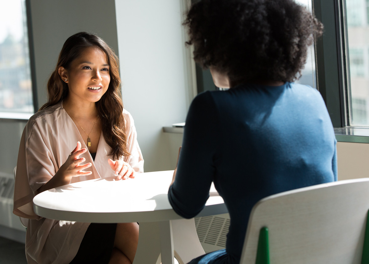 two people talking at a table