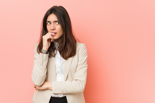 Young brunette in front of a pink background