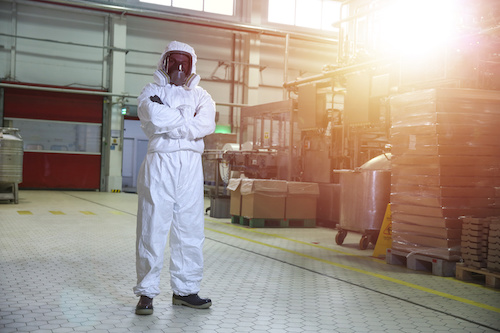 Worker in full factory PPE