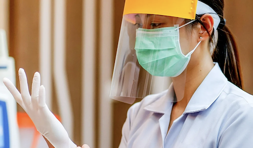 Healthcare worker with face mask and shield