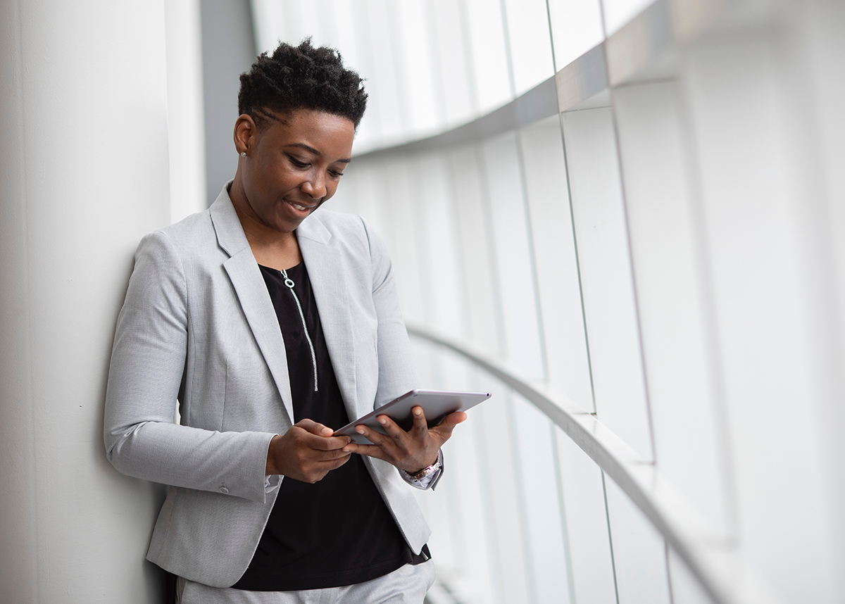 woman standing while holding tablet