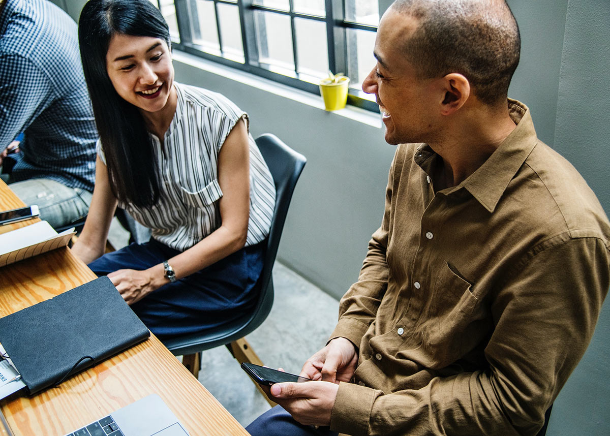 Young people laughing at work