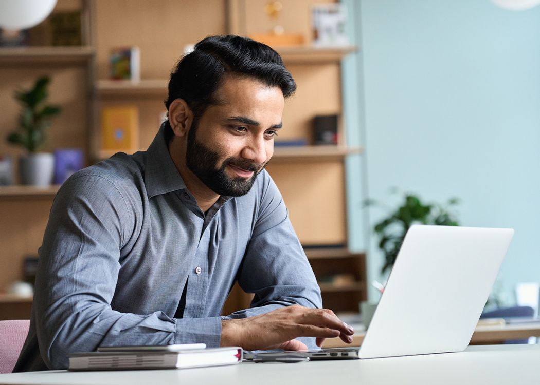 Man working at a desk on his laptop