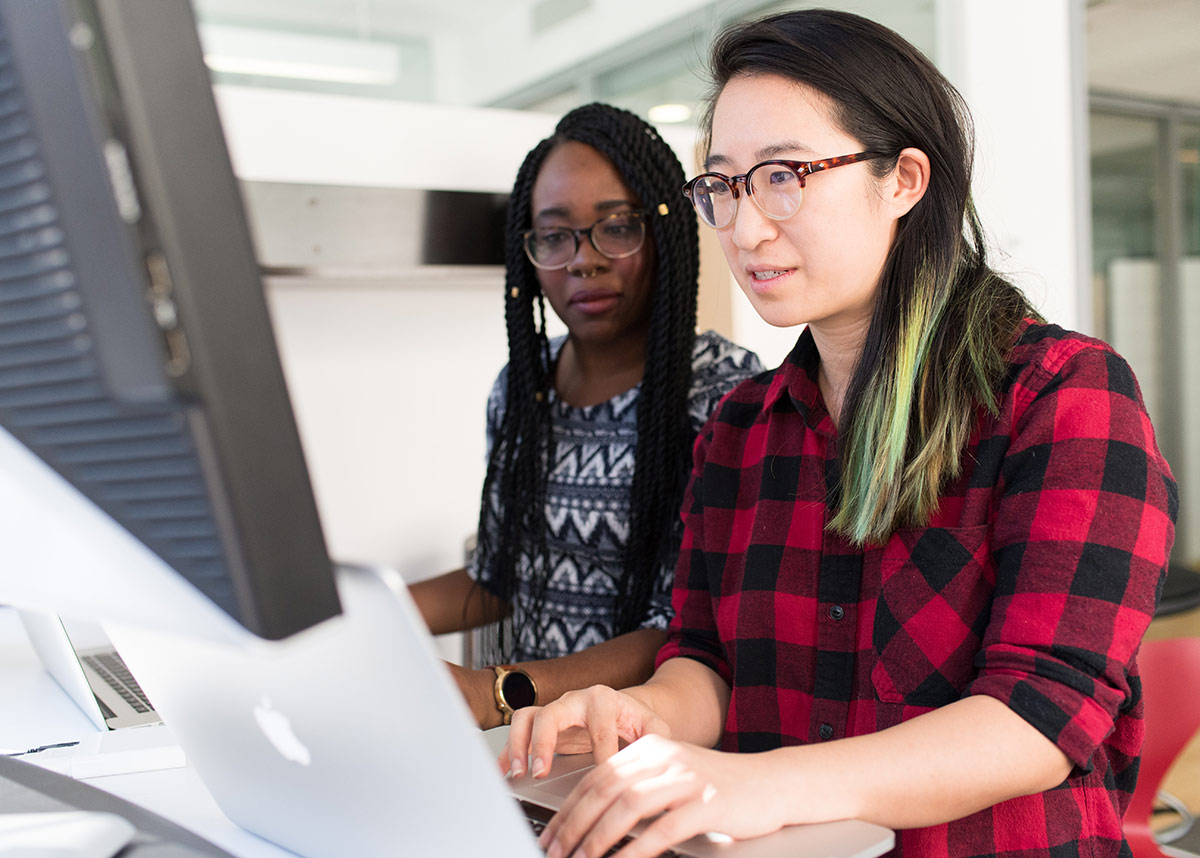 two women working at a computer