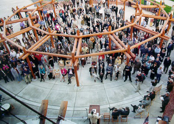 Large gathering of people for the opening ceremony in the building plaza