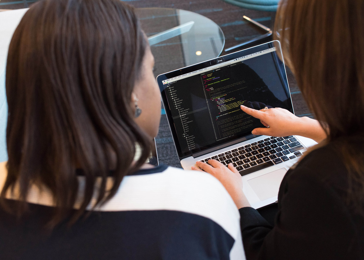 Two women looking at a computer screen together