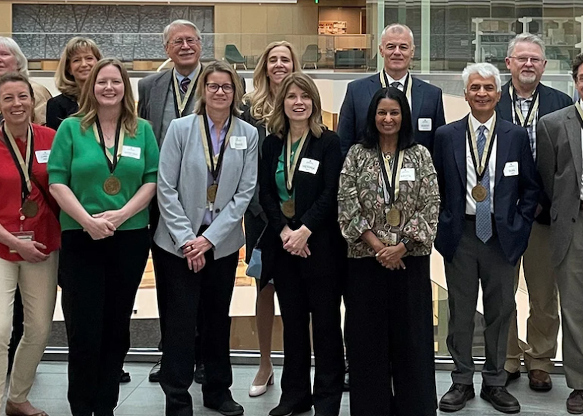 Faculty lined up with 25 years of service medals