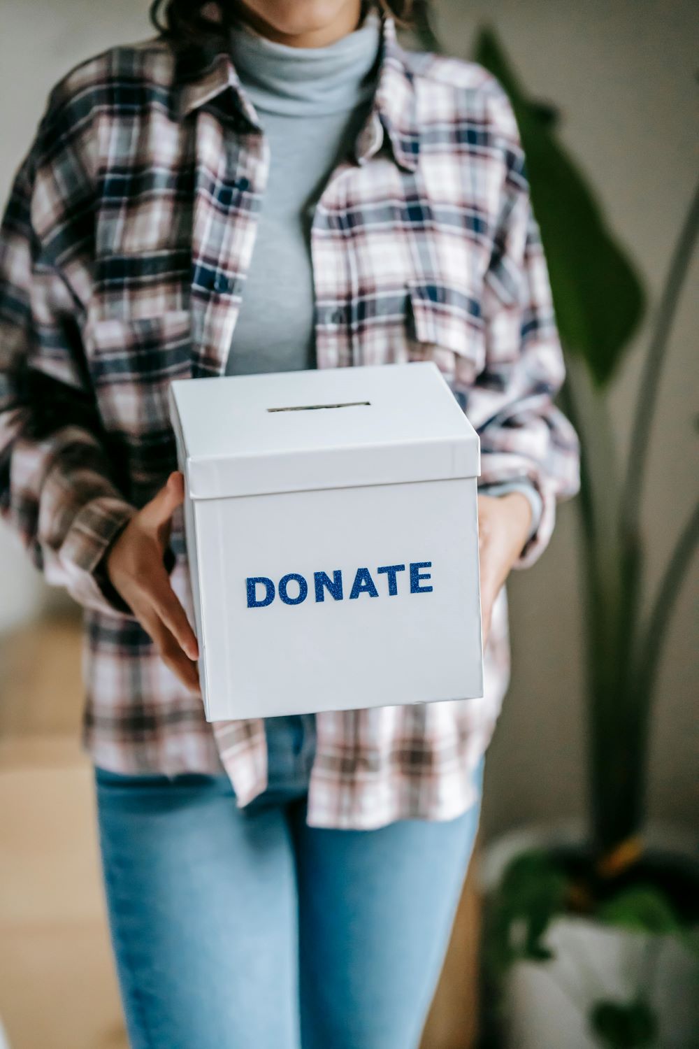 A woman holding a box that has 