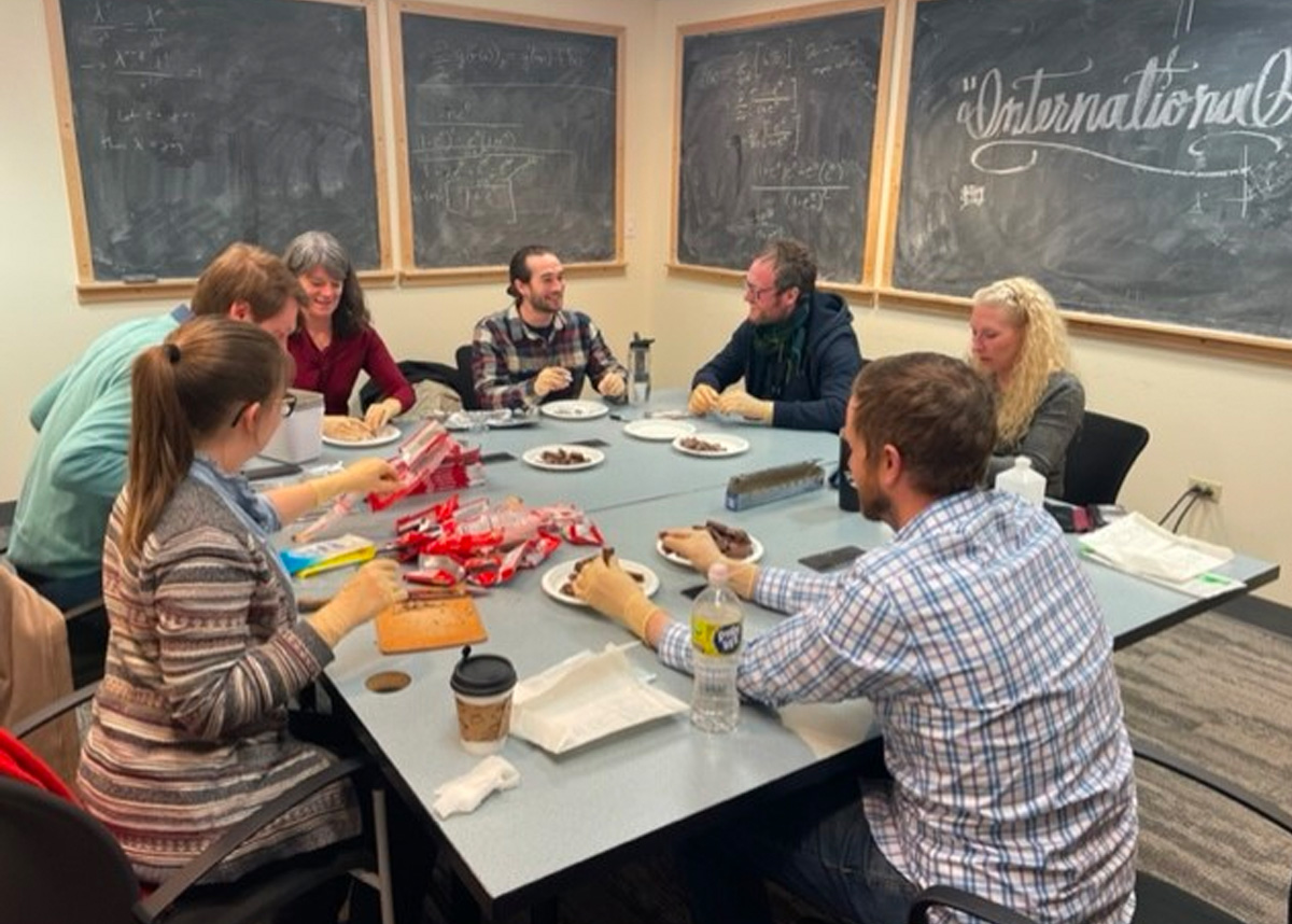 People sitting around table, teaching on epidemiology day