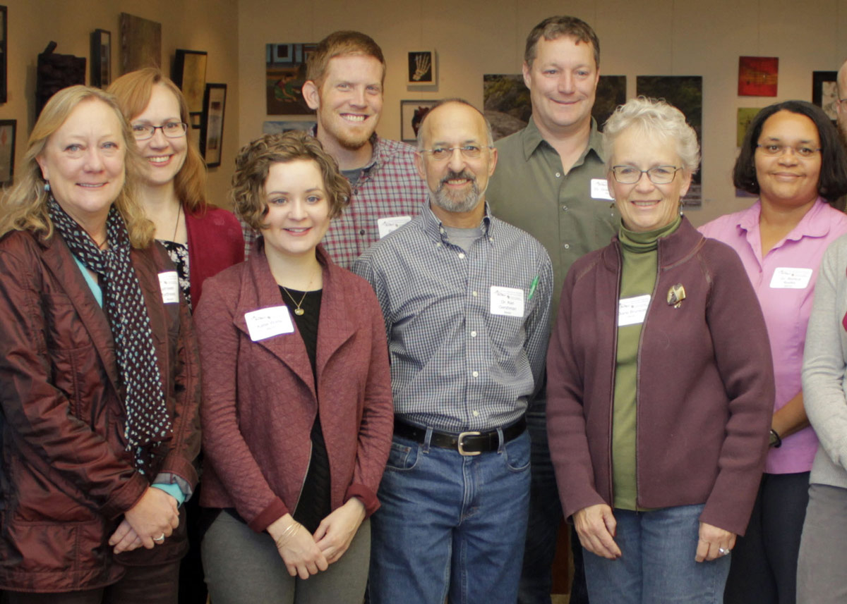 group of people standing and smiling