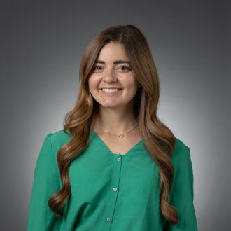 Headshot of woman wearing green shirt