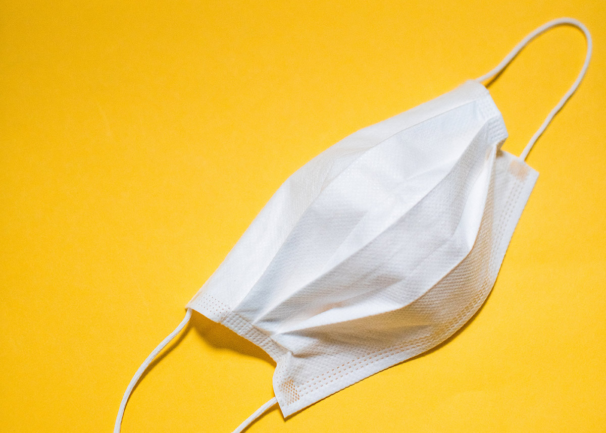 white mask on yellow background