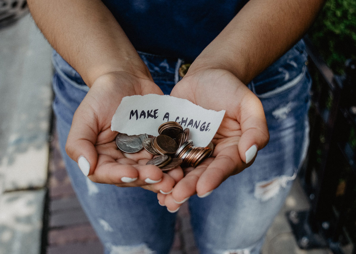 hands with change in them and a note that reads 