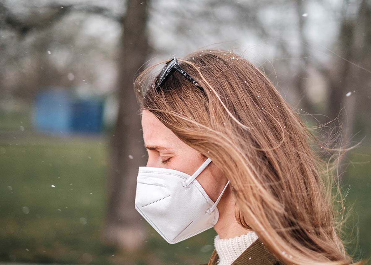 Women outdoors wearing a mask