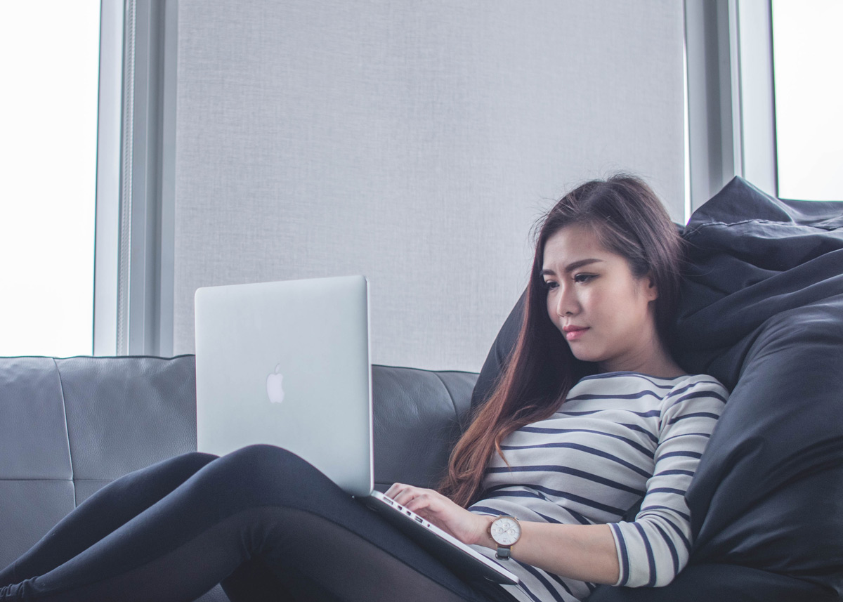 woman sitting with a laptop in her lap