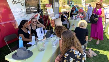 people working a table at event