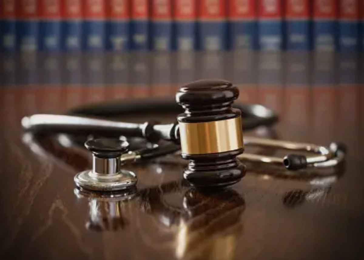 Stethoscope and gavel on wood table