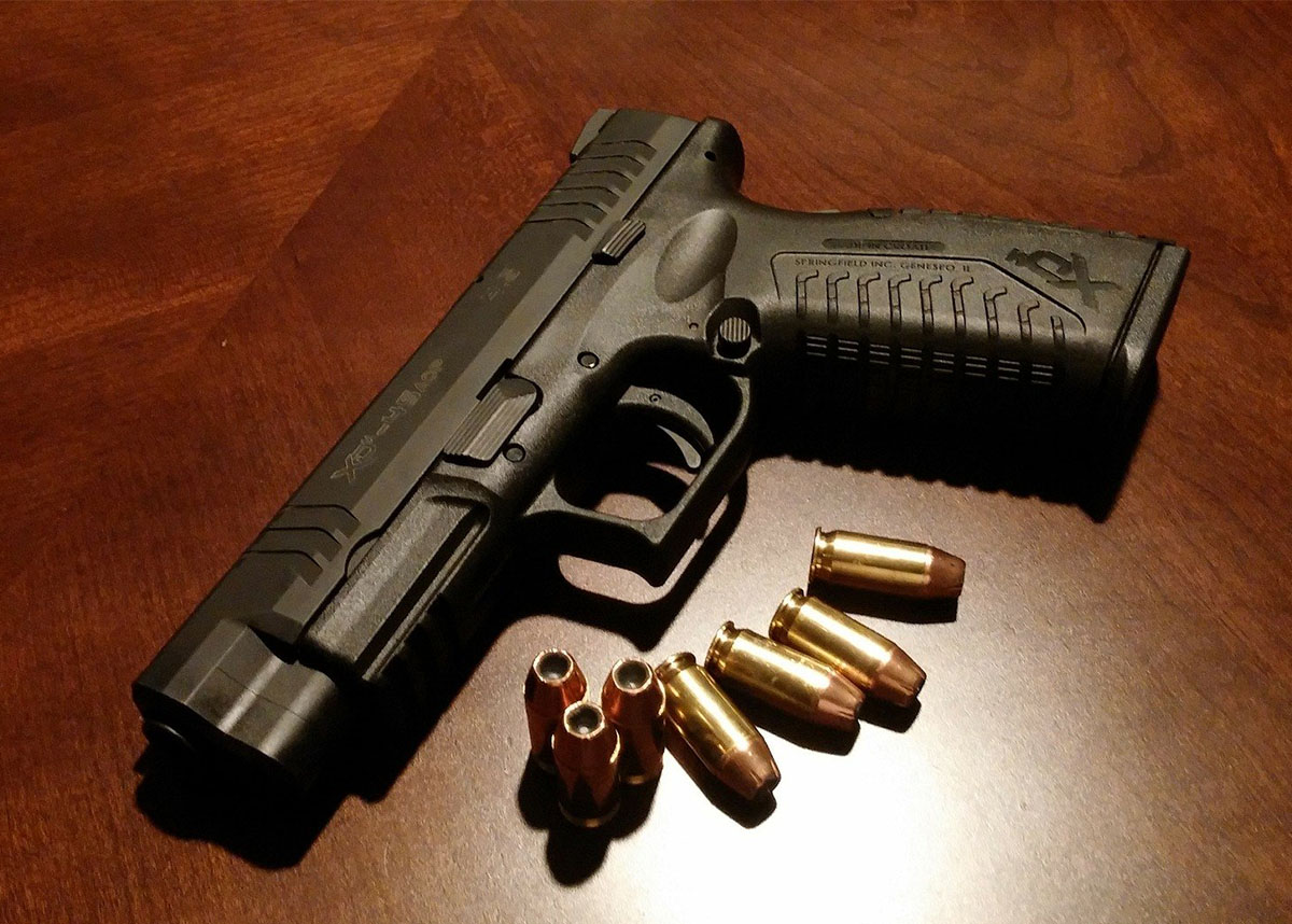 Pistol on a table with bullets