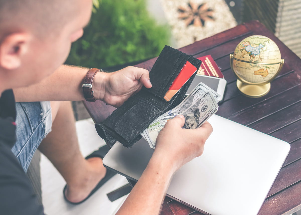 man pulling bills out of wallet