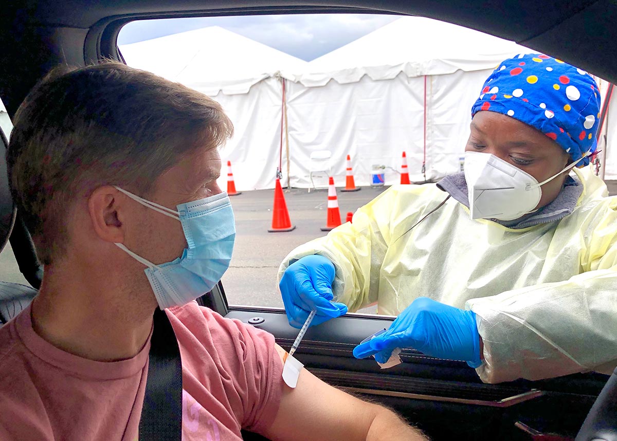 person getting vaccinated at a drive up clinic