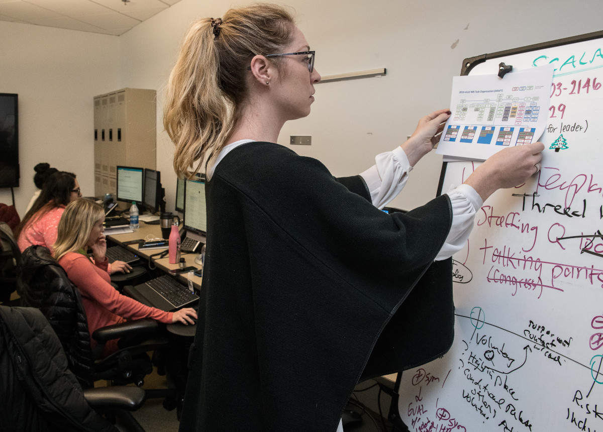 woman writing on whiteboard