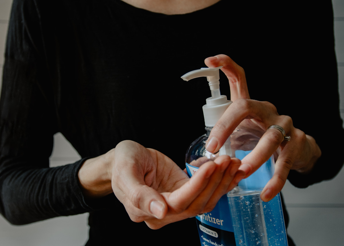 woman using hand sanitizer