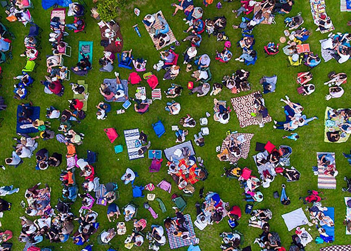 A crowd of people sitting outside