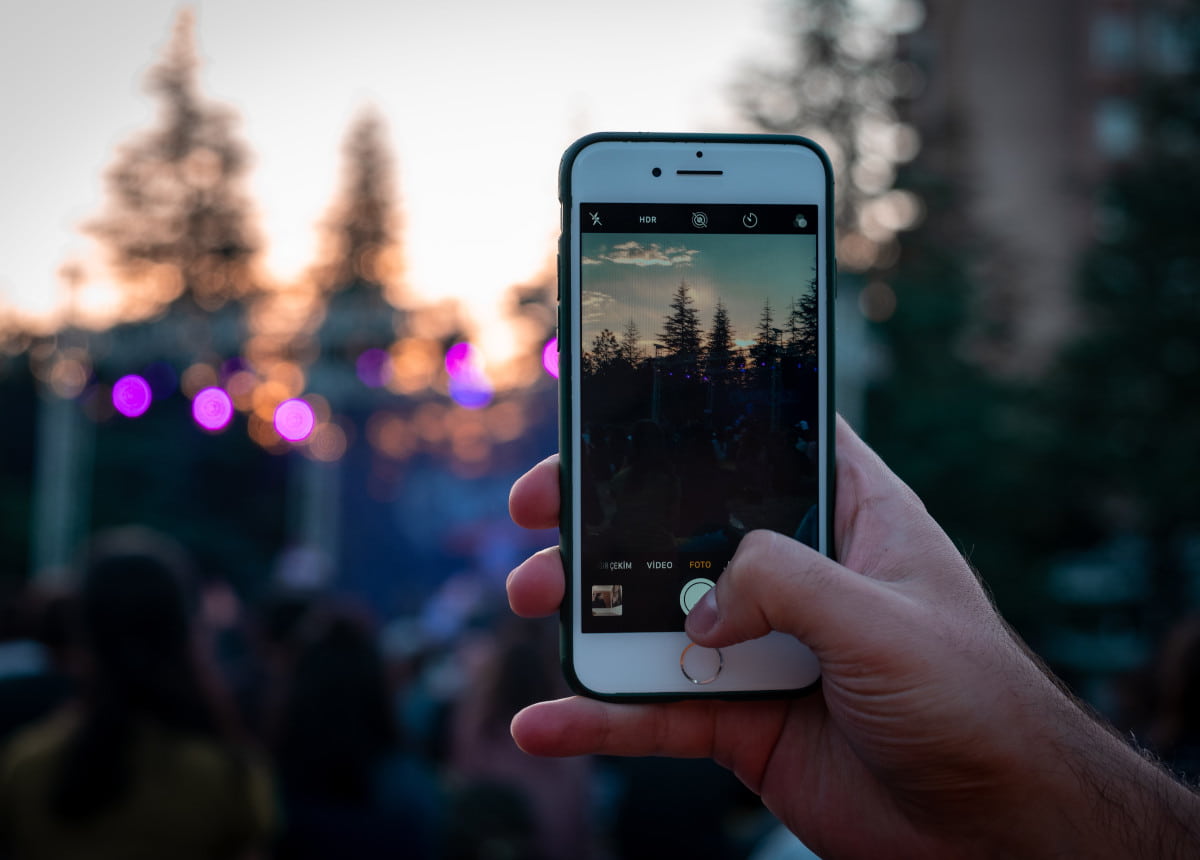 phone taking photo of trees in mountains