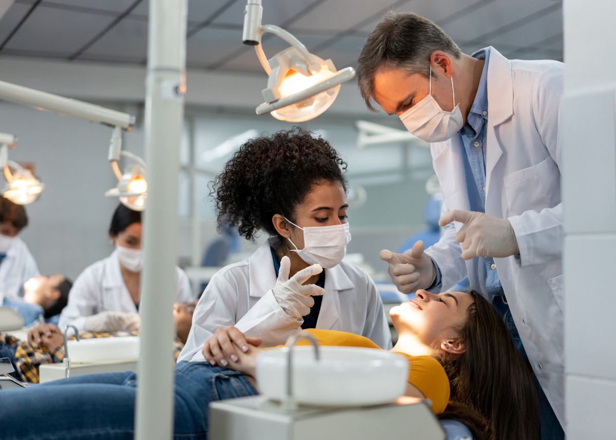 Instructor helping student look at a patient