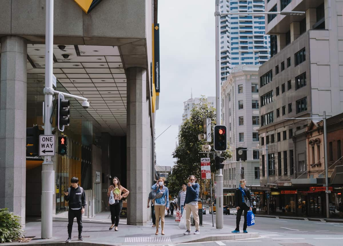 people using crosswalk wearing masks