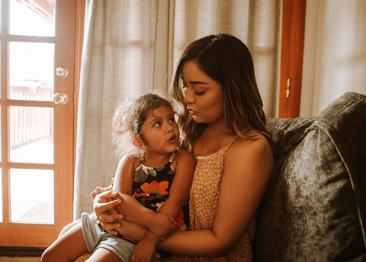 woman and child sitting together on a couch