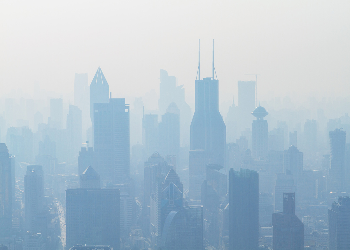 hazy aerial view of a city with smoke and pollution