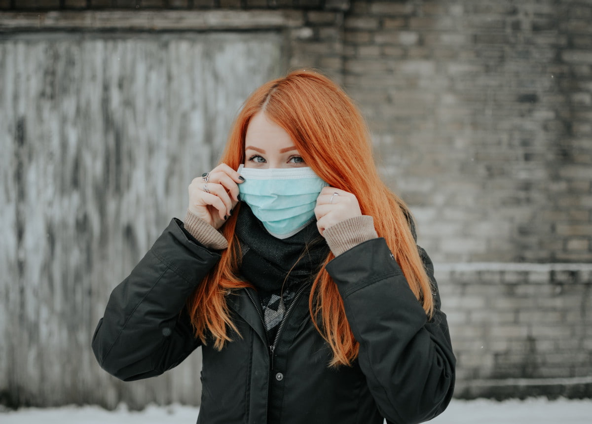 woman wearing mask looking at camera