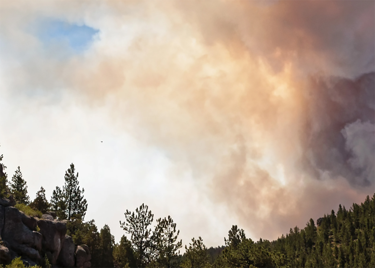 Smoke plume over mountain ridge