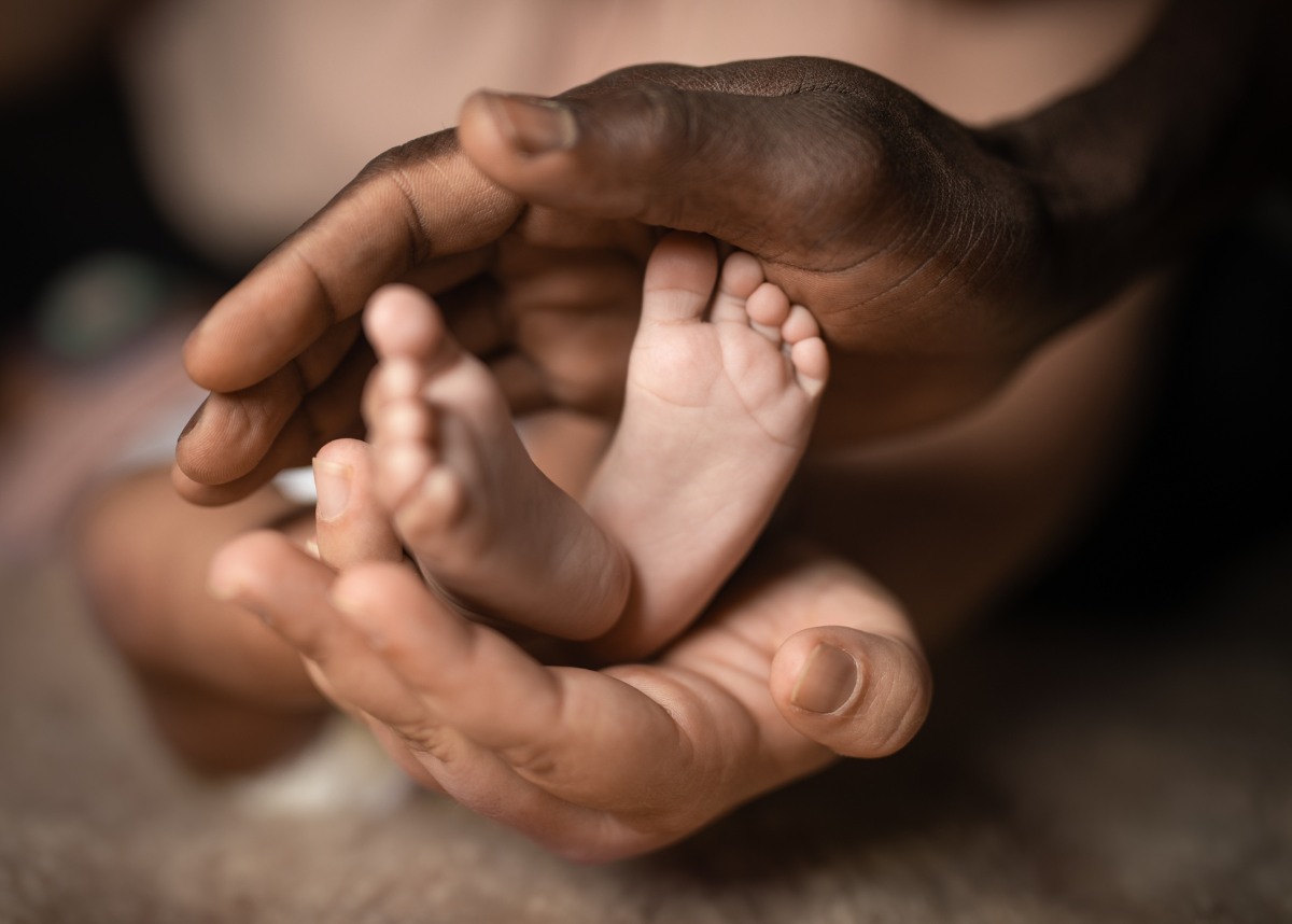 Image of baby's feet in hands