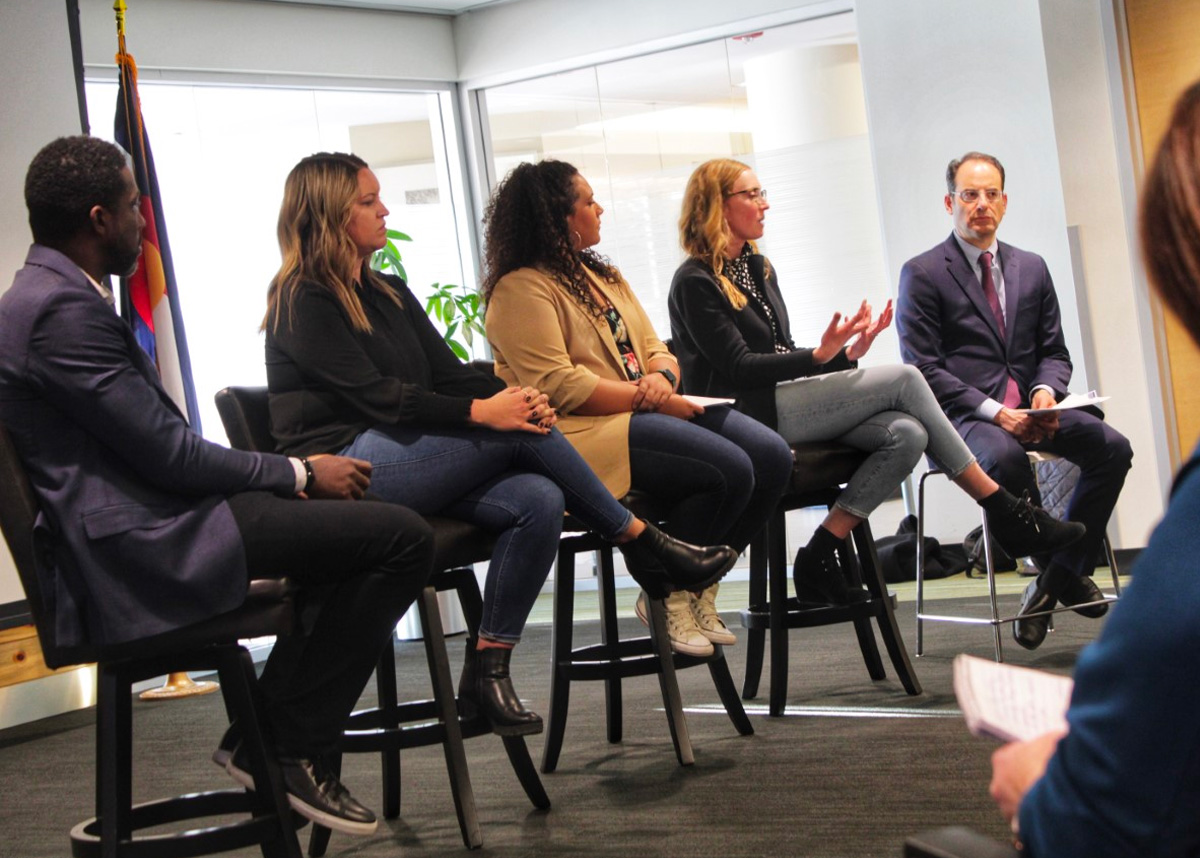 Panel of professionals sitting in chairs