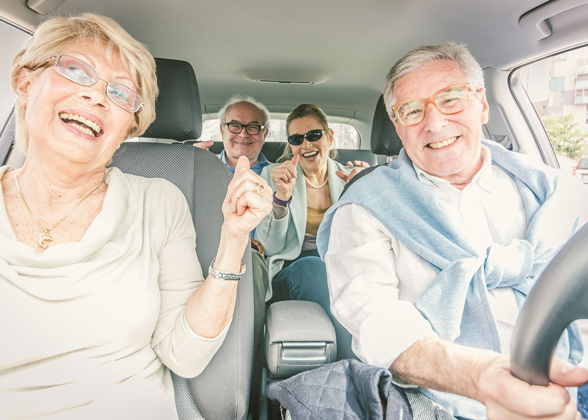 Four elderly people in a car