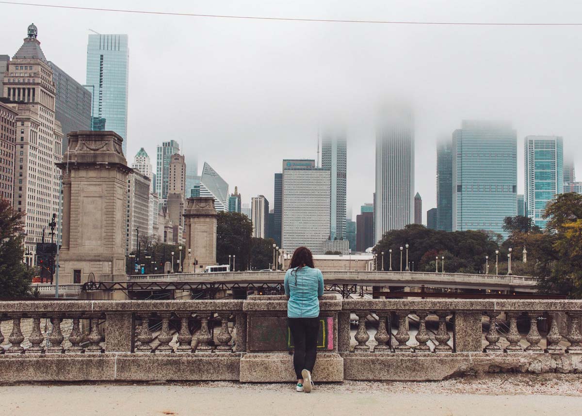 Woman standing facing cityscape