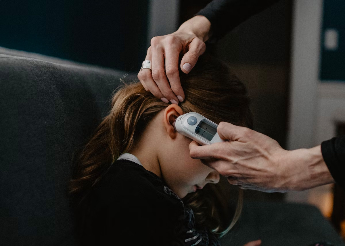 Person taking a childs temperature