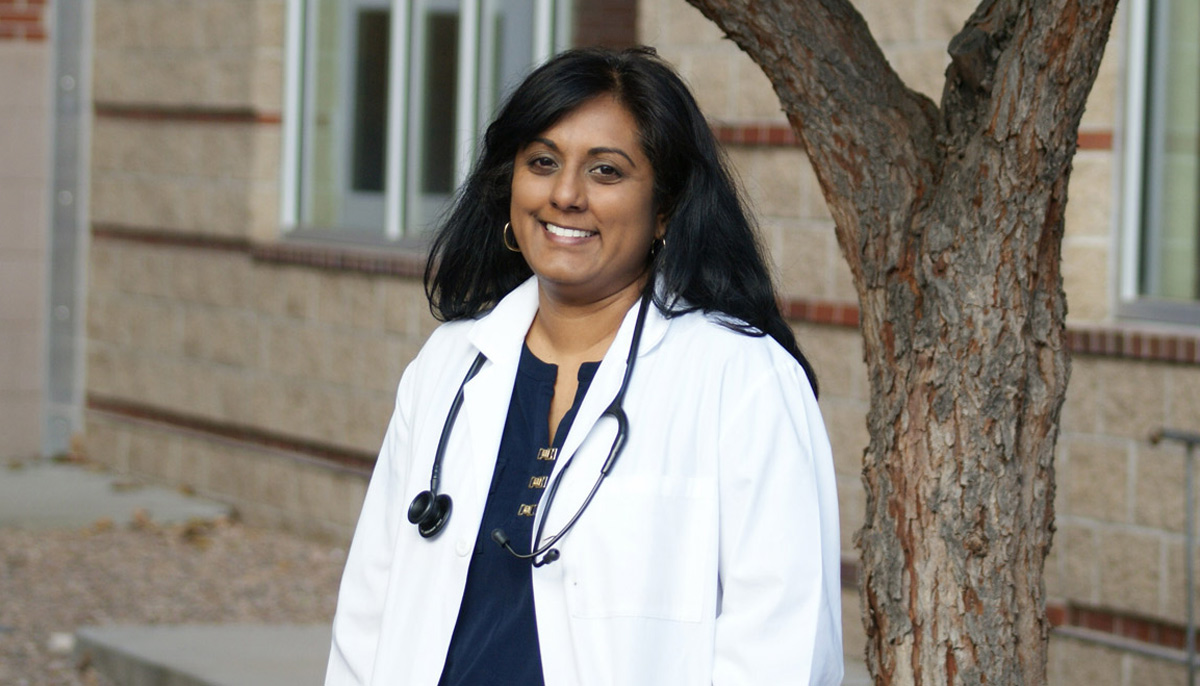 MAP ERC trainee smiling in a white coat with a stethoscope